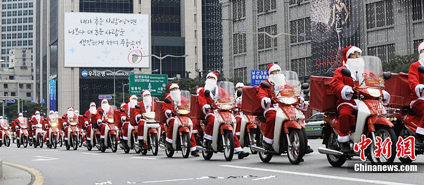 South Korean postmen wearing Santa Claus costumes distribute mails by motorbikes in the street during an event in Seoul, capital of South Korea on Dec. 13, 2010. Christmas is one of the biggest holidays in South Korea. [Xinhua]