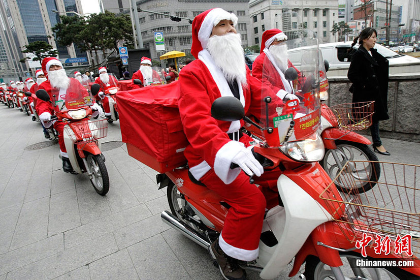 South Korean postmen wearing Santa Claus costumes distribute mails by motorbikes in the street during an event in Seoul, capital of South Korea on Dec. 13, 2010. Christmas is one of the biggest holidays in South Korea. [Xinhua]