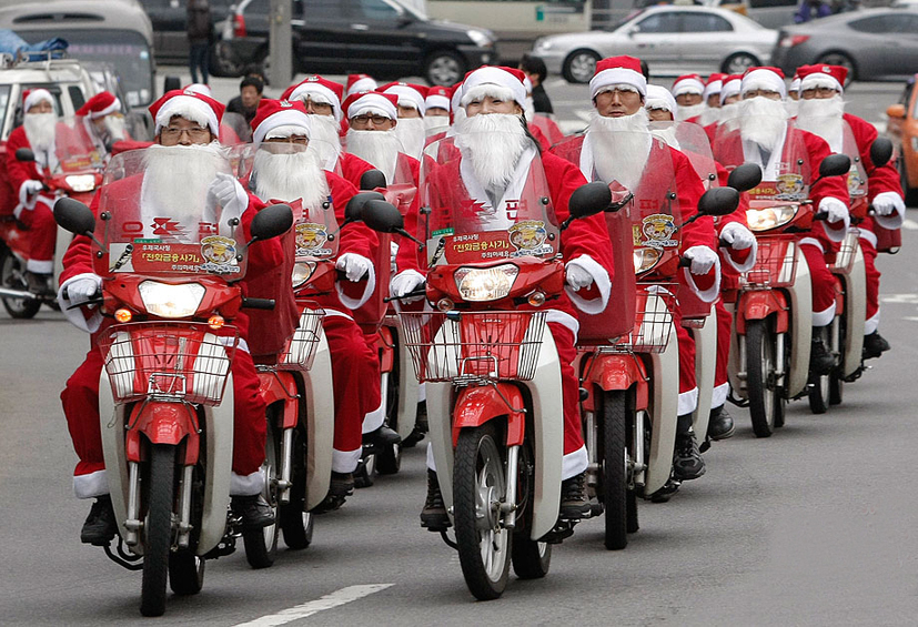 South Korean postmen wearing Santa Claus costumes distribute mails by motorbikes in the street during an event in Seoul, capital of South Korea on Dec. 13, 2010. Christmas is one of the biggest holidays in South Korea. [Xinhua]