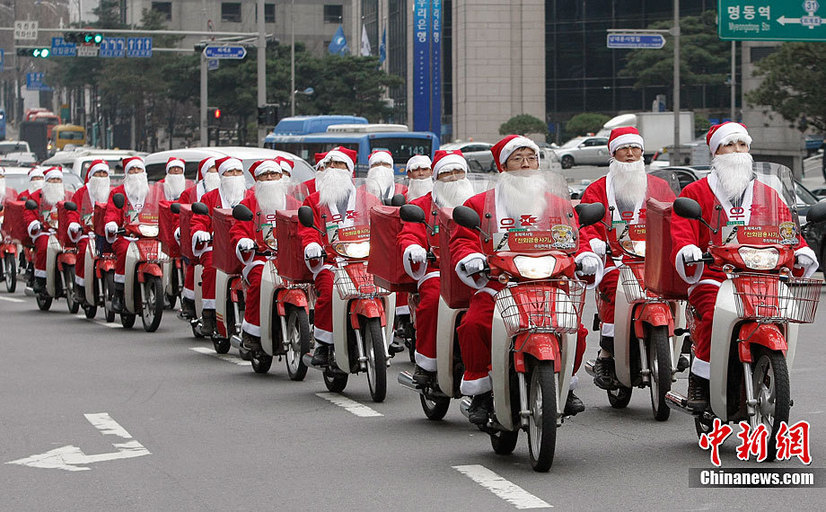 South Korean postmen wearing Santa Claus costumes distribute mails by motorbikes in the street during an event in Seoul, capital of South Korea on Dec. 13, 2010. Christmas is one of the biggest holidays in South Korea. [Xinhua]