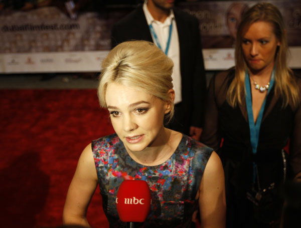 British actress Carey Mulligan speaks to the media during her arrival on the red carpet for the opening ceremony of the 7th edition of the Dubai International Film Festival December 12, 2010.