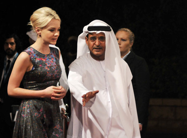 British actress Carey Mulligan (L) is greeted by Chairman of the event Abdel Hamid Jumaa on the red carpet for the opening ceremony of the 7th edition of the Dubai International Film Festival December 12, 2010.