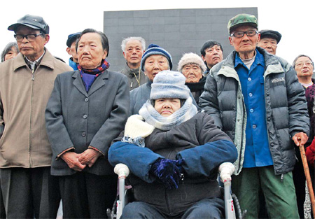 Nanjing scars still raw Ha Menghe (in wheelchair) and other survivors of the Nanjing Massacre attend a memorial ceremony on Monday in the capital city of Jiangsu province to mark the 73rd anniversary of the tragedy. More than 300,000 Chinese people were killed by the Japanese invaders in December 1937, during a six-week-long orgy of killing, burning, looting and raping. [Photo by Han Hua / for China Daily]