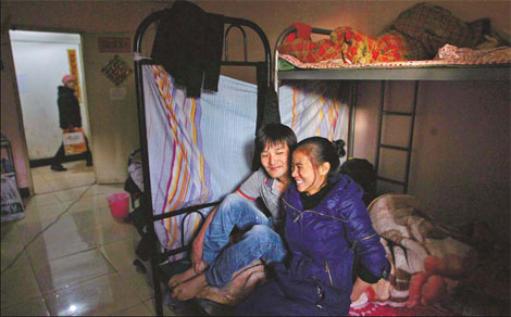 He Quanji and his wife, from Fujian province, get comfortable in their basement in Chaoyang district. 