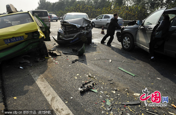 Vehicle fragments are seen on a highway after 52 car pile-ups in Chengdu, Southwest China&apos;s Sichuan province, Dec 13, 2010.