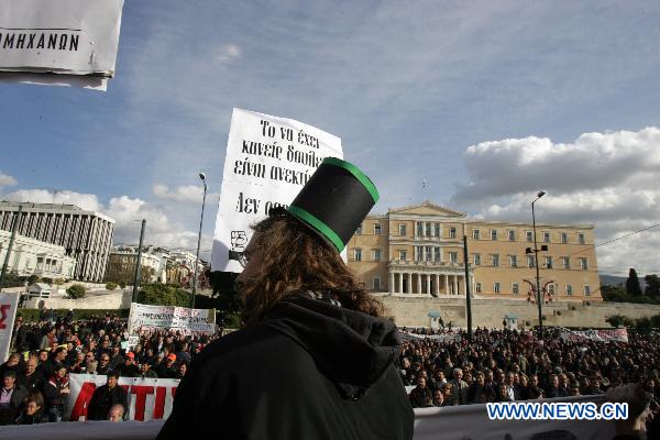 A Greek demonstrator dressed like an industrialist attends a rally in Athens, capital of Greece, Dec. 14, 2010. Labor unions of public servants staged protests over austerity measures introduced by the government to tackle a severe economic crisis in Greece. [Marios Lolos/Xinhua]