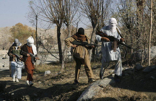 Taliban fighters pose with weapons in an undisclosed location in Nangarhar province in Afghanistan in this December 13, 2010 photo. [Xinhua]