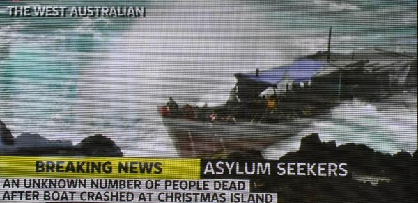 A boat full of asylum seekers is smashed by violent seas off Australia's Christmas Island, as shown in this Channel 7 TV framegrab of a photo released by The West Australian on December 15, 2010. [Xinhua]