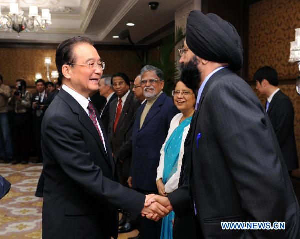 Chinese Premier Wen Jiabao (L, front) shakes hands with an Indian winner of 'China-India Friendship Award' during the awarding ceremony in New Delhi, India, Dec. 15, 2010. [Li Tao/Xinhua]