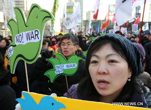 South Korean protestors hold banners and shout slogans during an anti-government rally in Seoul, capital of South Korea on Dec. 18, 2010. South Korea has declared plans for a live shell artillery drill in the waters southwest of Yeonpyeong Island on a selected date from Dec. 18-21 depending on weather conditions.