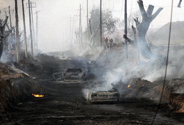 Destroyed cars are seen after the explosion of a Petroleos Mexicanos (PEMEX) pipeline in the village of San Martin Texmelucan in Puebla State, Mexico, on Dec. 19, 2010. At least 27 people were killed early Sunday when the oil pipeline exploded in central Mexico, the authorithies said. [Rafael Murillo/Xinhua]