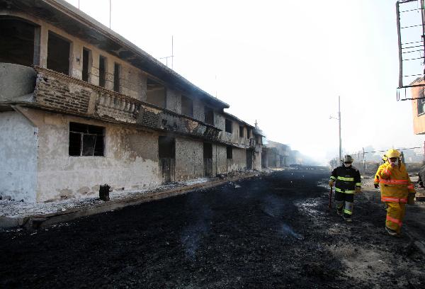 Mexican firefighters work at the site after the explosion of a Petroleos Mexicanos (PEMEX) pipeline in the village of San Martin Texmelucan in Puebla State, Mexico, on Dec. 19, 2010. At least 27 people were killed early Sunday when the oil pipeline exploded in central Mexico, the authorithies said. [Rafael Murillo/Xinhua]