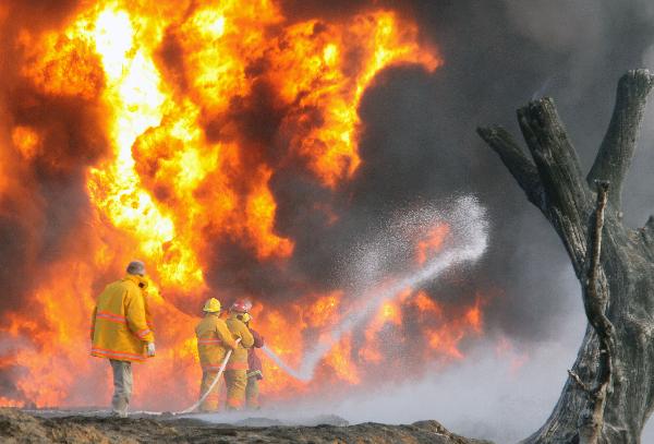 Mexican firefighters try to extinguish the fire after the explosion of a Petroleos Mexicanos (PEMEX) pipeline in the village of San Martin Texmelucan in Puebla State, Mexico, on Dec. 19, 2010. At least 27 people were killed early Sunday when the oil pipeline exploded in central Mexico, the authorithies said. [Rafael Murillo/Xinhua] 