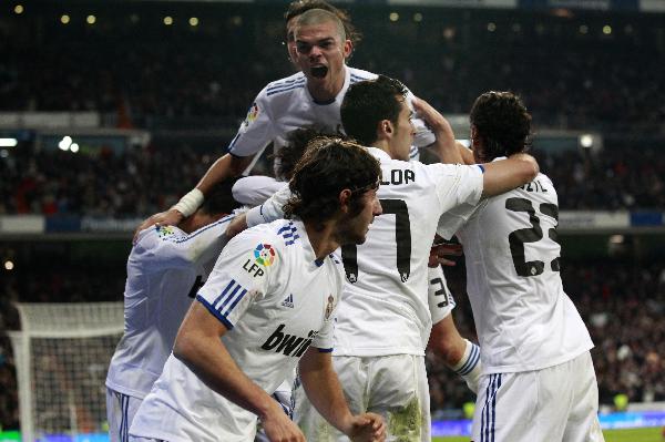 Real Madrid players celebrate Angel Di Maria's goal against Sevilla during their Spanish first division soccer match at Santiago Bernabeu stadium in Madrid December 19, 2010. (Xinhua/Reuters Photo)