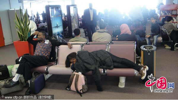 Some passengers are patiently awaiting their flights at various Orly terminals. Flights are delayed and cancelled at south of Paris Orly airport because of the heavy snow. [CFP]