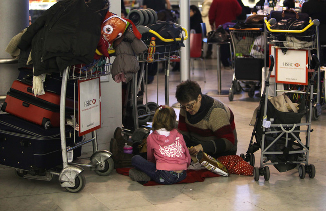 Some passengers are patiently awaiting their flights at Charles De Gaulle Airport on December 20, 2010 in Paris, France. Flights are delayed and cancelled at Charles De Gaulle Airport because of the heavy snow. [CFP] 