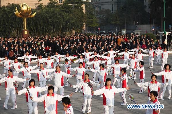 Macao citizens perform at the Golden Lotus Square in Macao Special Administrative Region, south China, Dec. 20, 2010, during the flag-raising ceremony marking the 11th anniversary of Macao&apos;s handover. [Xinhua]