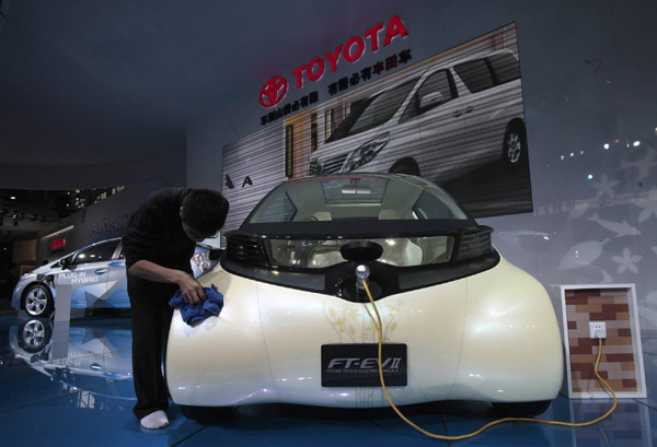 An employee wipes a Toyota electric FT-EV II concept car at the Guangzhou Autoshow Dec 20, 2010. [Agencies]