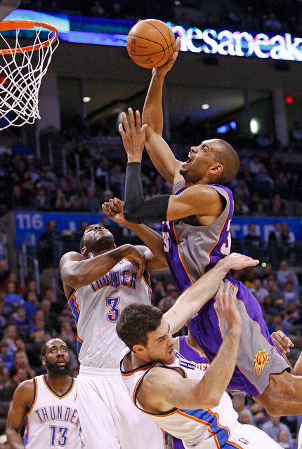  Phoenix Suns forward Grant Hill (right) goes over Oklahoma City Thunder's Nick Collison (front bottom) and DJ White.