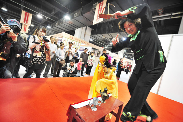 A puppeteer from Pingyang in Zhejiang province puts on a show in November at an exhibition featuring examples of China's intangible cultural heritage in Hangzhou, capital of the province. 