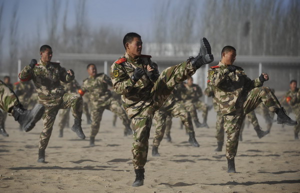 Members of Ningxia Armed Police Unit go through a drill at the opening ceremony of its recruit training in Ningxia Hui autonomous region on Dec 21, 2010. [Xinhua] 