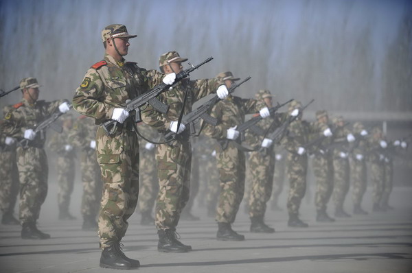 Members of Ningxia Armed Police Unit go through a drill at the opening ceremony of its recruit training in Ningxia Hui autonomous region on Dec 21, 2010. [Xinhua] 