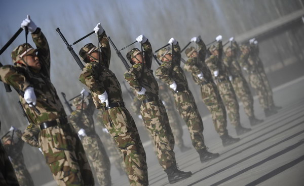 Members of Ningxia Armed Police Unit go through a drill at the opening ceremony of its recruit training in Ningxia Hui autonomous region on Dec 21, 2010. [Xinhua] 