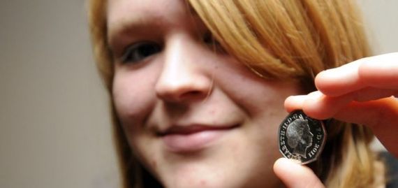 Student Sarah Legg shows off her 50p coin with next year's date on it.