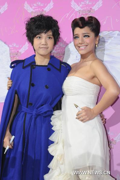 Singers Li Xiaoyun (L) and Jiang Yingrong pose at the awarding ceremony of the 3rd New Artist Awards of Top Chinese Music Chart in Beijing, capital of China, Dec. 19, 2010. The awarding ceremony of the 3rd New Artist Awards of Top Chinese Music Chart was held here Sunday, in which Chinese youth music talents were given awards for their breakthroughs in the year of 2010.