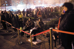 People are waiting in a queue outside the office of the Hongye Xingyuan residential compound, Fengtai district.