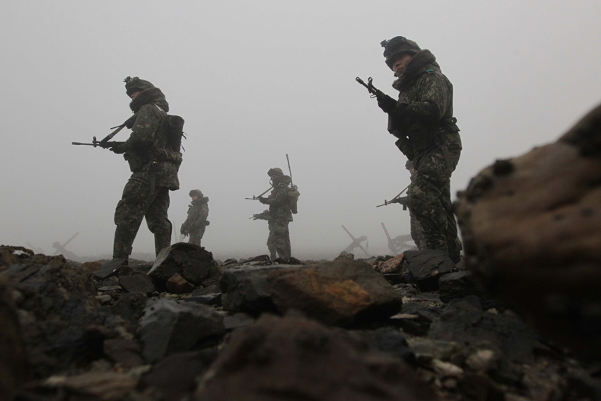 In this Tuesday, Dec. 21, 2010 image, South Korean Army soldiers patrol near the seaside in Dangjin, south of Seoul, South Korea.