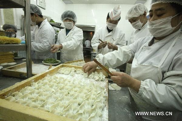 Chefs make dumplings at a restaurant in Beijing, capital of China, Dec. 22, 2010, also the day of Dongzhi, the traditional Chinese winter solstice festival. People in north China have a tradition of eating dumplings on the festival to protect their ears from frostbite. [Xinhua]