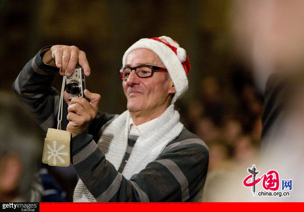 A man in Santa Claus hat attends the Christmas special draw of lottery at Palacio de Congresos on December 22, 2010 in Madrid, Spain. [CFP]