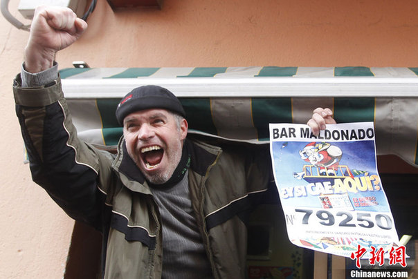 A winner of &apos;El Gordo&apos; shows his winning ticket at the bar which sold the largest amount of winning tickets for the spanish lottery on December 22, 2010 in Palleja near Barcelona, Spain.[CFP]