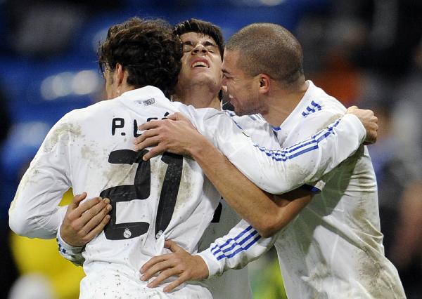 Real Madrid's Pedro Leon (L) celebrates his goal with his team-mates Pepe (R) and Alvaro Morata during their Spanish King's Cup soccer match at Santiago Bernabeu stadium in Madrid December 22, 2010. Real Madrid won 8-0. (Xinhua/Reuters Photo)