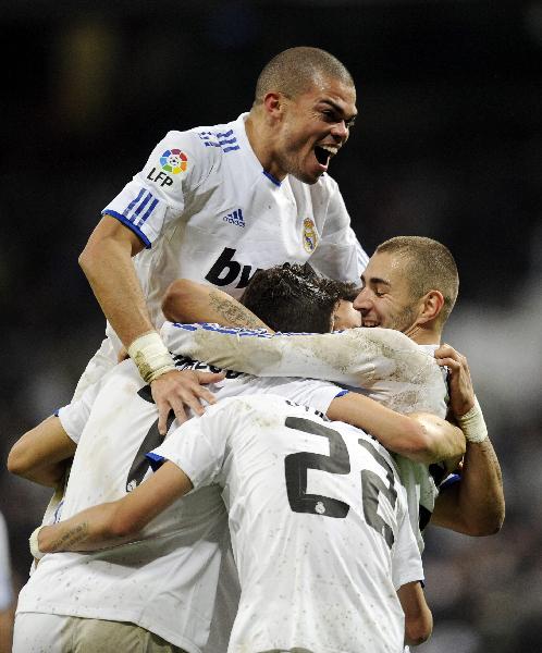 Real Madrid's players celebrate a goal during their Spanish King's Cup soccer match against Levante at Santiago Bernabeu stadium in Madrid December 22, 2010. (Xinhua/Reuters Photo)