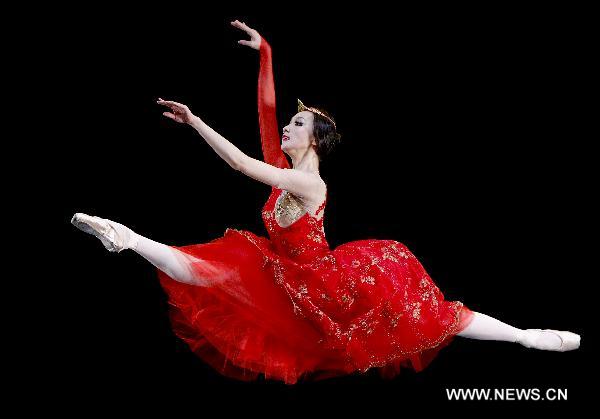 Ballet artist Qiu Siting performs on stage 'Chopin on Point', a symphony ballet to commemorate the 200th anniversary of birthday of Polish composer and pianist Fryderyk Chopin, in Beijing, capital of China, Dec. 22, 2010.