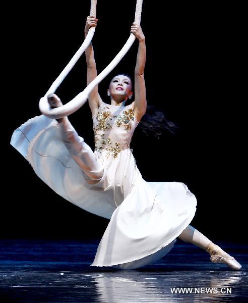 Ballet artist Qiu Siting performs on stage 'Chopin on Point', a symphony ballet to commemorate the 200th anniversary of birthday of Polish composer and pianist Fryderyk Chopin, in Beijing, capital of China, Dec. 22, 2010.