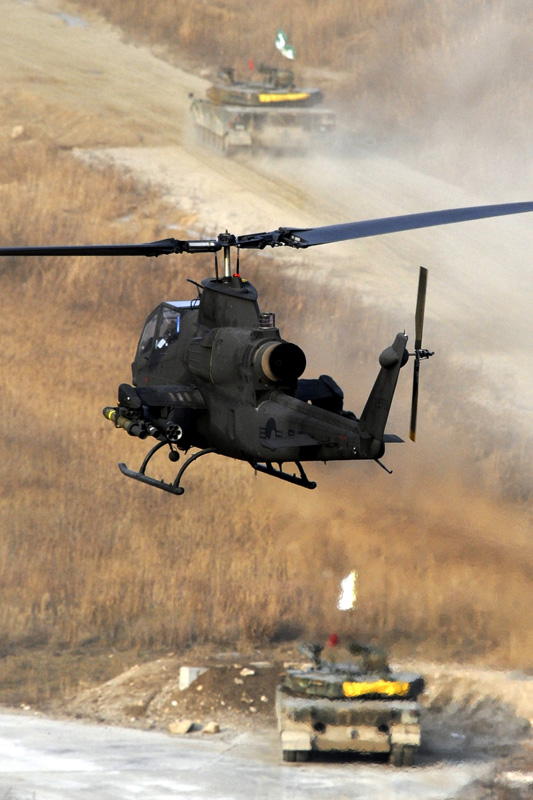 A helicopter and tanks are seen during a military drill in Pocheon, South Korea, on Dec. 23, 2010. [Xinhua]