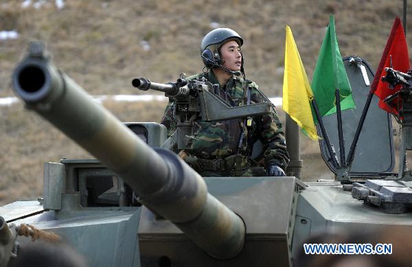 A South Korean soldier is seen on a tank during a military drill in Pocheon, South Korea, on Dec. 23, 2010. [Pool/Xinhua]