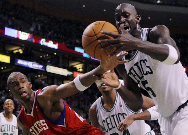 Philadelphia 76ers guard Jodie Meeks (2nd L) and Boston Celtics forward Kevin Garnett reach for a loose ball in the third quarter of their NBA basketball game in Boston, Massachusetts December 22, 2010. Celtics won 84-80. (Xinhua/Reuters Photo) 