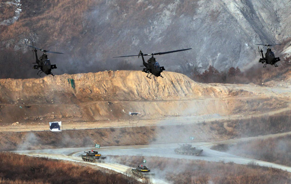 Three Cobra helicopters fly in formation over K-1 tanks during the ROK's largest-ever air and ground military exercise on the Seungjin Fire Training Field in Pocheon on Thursday. [Photo/Xinhua]