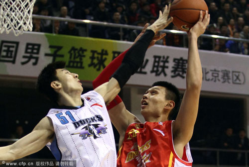 Beijing Duck's Ji Zhe (51) goes up for a blockshot against Byi Fubang's Xu Zhonghao during a Chinese Basketball Association (CBA) game on Friday December 24, 2010, Beijing.