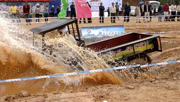 A participant takes part in a tractor race in Qiongzhong, south China&apos;s Hainan Province, Dec. 26, 2010. The first Hainan Tractor Skills Competition kicked off on Sunday, a total of 54 farmers of Hainan took part in the competition.[Xinhua]