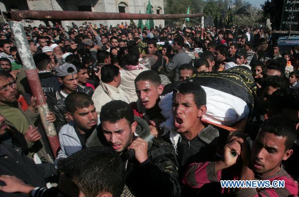 Mourners carry the bodies of two Palestinian militants during their funeral in Khan Younis, southern Gaza Strip, on Dec. 26, 2010. Israeli forces killed two Palestinian militants Sunday morning in armed clashes near the Gaza Strip borders, security and medical sources said. The killing of the two militants, who Islamic Jihad movement claims belong to its military wing, came amid a new wave of cross-border violence which escalated for recent days. [Khaled Omar/Xinhua]