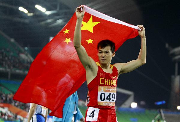 Chinese sprinter Lao Yi celebrates after he surprisingly won the 100m gold medal in the Asia Games in Guangzhou on Monday evening. (Xinhua Photo)