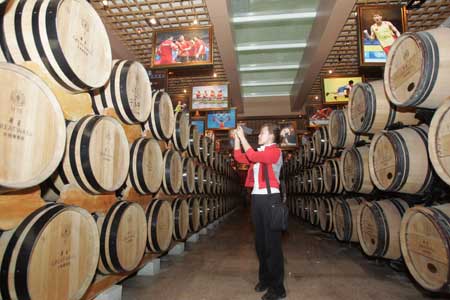 A woman tours a cellar of the Great Wall Wine production base in 2009 in Changli county, Hebei Province. 