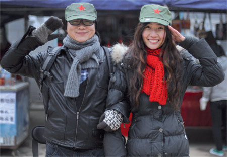 A couple wearing Red Army caps give a salute Sunday in Shaoshan, Hunan Province, the birthplace of late Chinese leader Mao Zedong.
