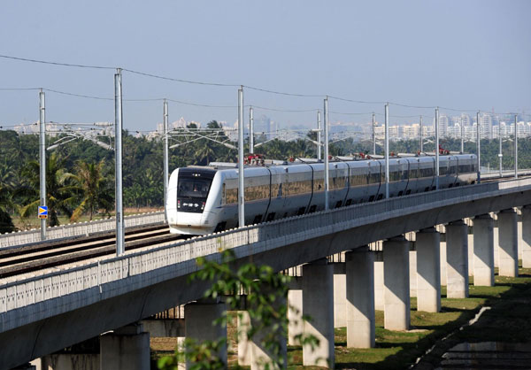 A bullet train runs during a trial operation on the East Ring Railway, or Donghuan Railway linking Haikou, capital of South China's island province Hainan and Sanya city, Dec 26, 2010. 