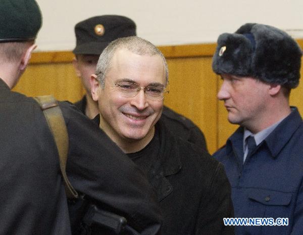 Former Yukos tycoon Mikhail Khodorkovsky is escorted by policemen at a court in Moscow, capital of Russia, Dec. 27, 2010. Mikhail Khodorkovsky was found guilty on Monday by the court in his second trial on charges of embezzlement, Russian local news reports said. [Xinhua]